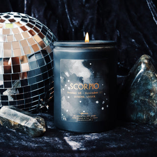 scorpio astrological candle on velvet with a disco ball and crystals