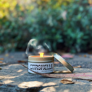 A 6 oz gold tin vessel with matching gold lid. White & Black candle label that says "Citronella". Scent is Citronella. Made with soy wax.