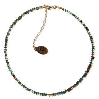 green turquoise stone. petite beads with small gold accent beading around the necklace. The 14k Gold Fill chain is adorned with a draping “Often Wander” charm down the back.