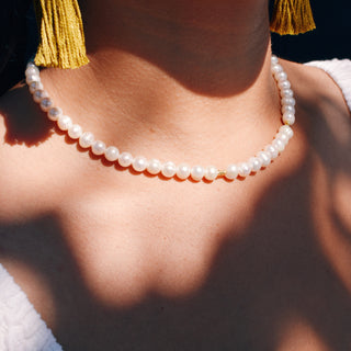 classic pearl necklace with a few small gold bead accents.