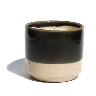 6oz half solid black & half speckled cream colored ceramic candle vessel  with the scent of blackberry amber made with soy wax.
