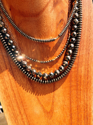 layers of pyrite necklaces shining in the sun