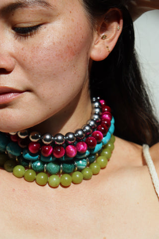Close-up of a woman wearing a colorful beaded necklace.