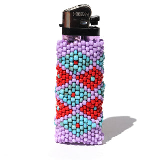 A clear plastic lighter covered in a colorful beaded sleeve with geometric patterns of purple, turquoise, and red, photographed on a white background with a soft shadow.