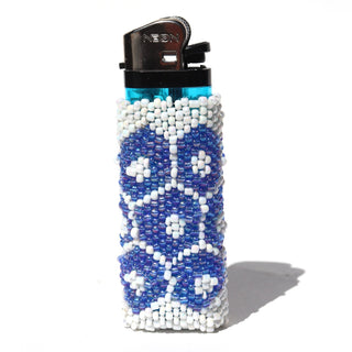 A clear plastic lighter covered in a beaded sleeve with a geometric pattern of blue and white beads, shown on a white background with a soft shadow.
