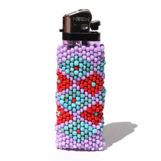 A classic NEON lighter covered in a colorful beaded sleeve with geometric patterns of red, light blue, and lavender purple, set against a plain white background.