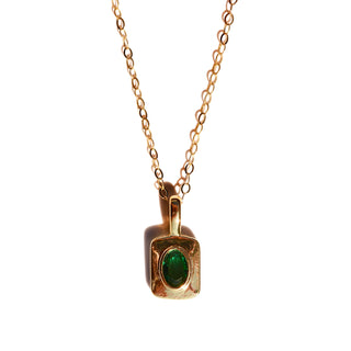 A rounded square 16k gold filled brass  pendant with an oval emerald colored faceted stone on dainty 14k gold fill chain. 