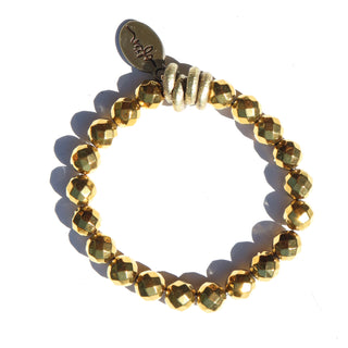 shiny gold hematite with brass accent beads and an Often Wander charm.