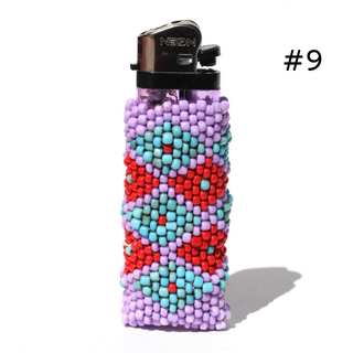 A beaded lighter cover on a clear NEON lighter, featuring a geometric pattern of red, light blue, and lavender purple beads. The lighter is shown on a white background with a soft shadow and the text '#10' in the top right corner.