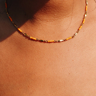 24k gold plating over brass chain with petite orange beads accenting around the chain.