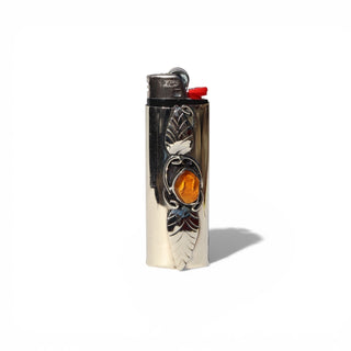 Decorative lighter with leaf design on a white background