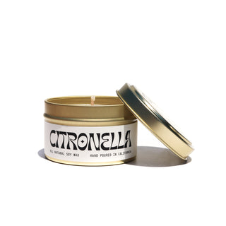 A 6 oz gold tin vessel with matching gold lid. White & Black candle label that says "Citronella". Scent is Citronella. Made with soy wax.