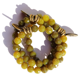 Faceted olive jade beads with a few brass accent beads and a brass Often Wander charm.