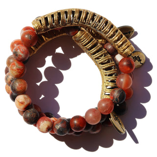 Red and black smooth matte beads combined with a brass cuff and an Often Wander charm.