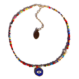 a colorful assortment of african beads with a evil eye pendant.