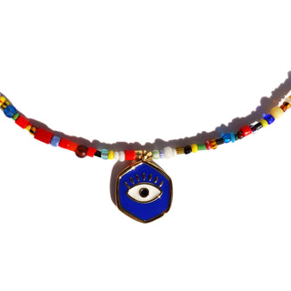 a colorful assortment of african beads with a evil eye pendant.